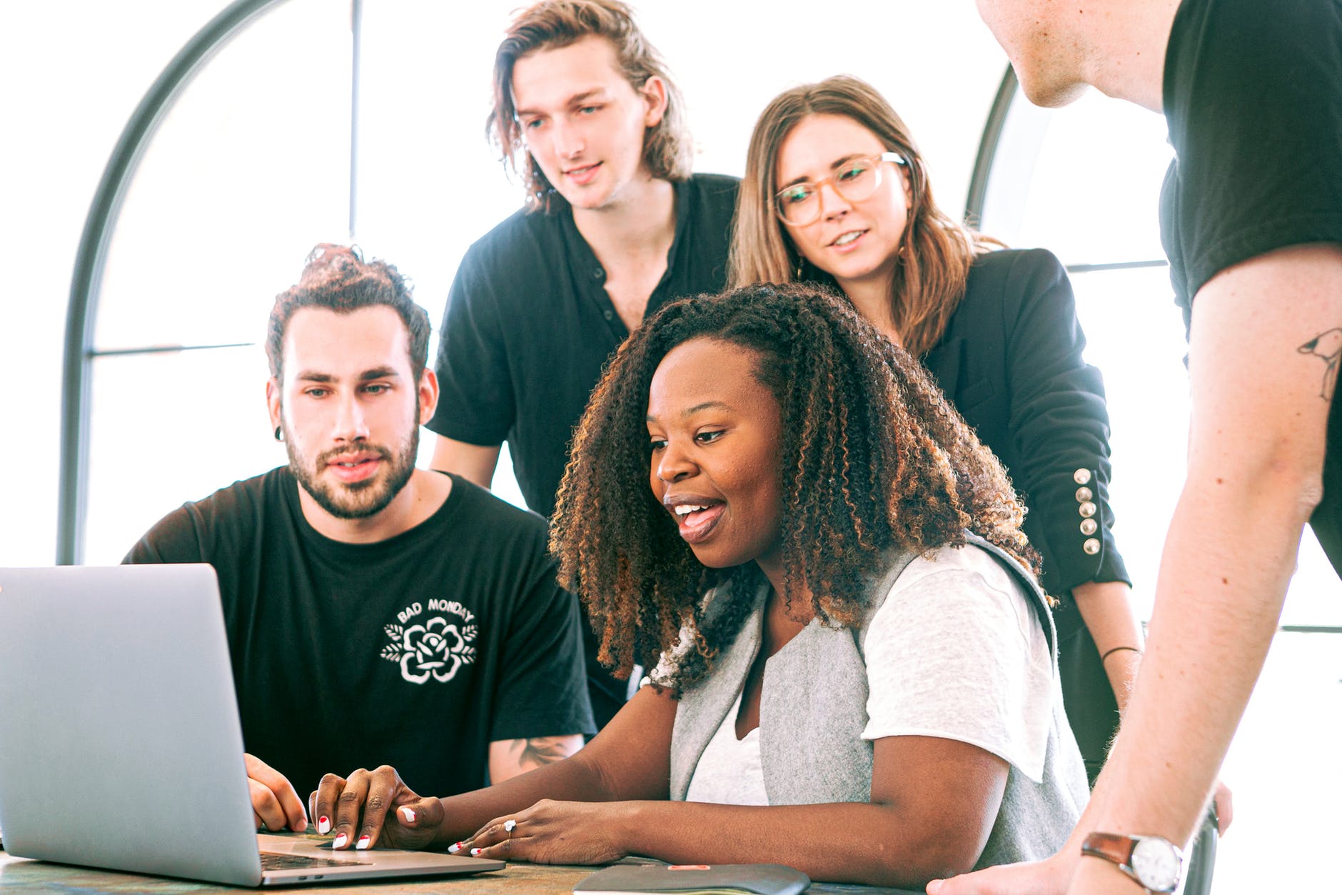 diversity in the workplace: black woman sharing her presentation with her white colleagues